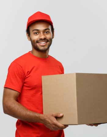 delivery-concept-portrait-happy-african-american-delivery-man-red-cloth-holding-box-package-isolated-grey-studio-background-copy-space